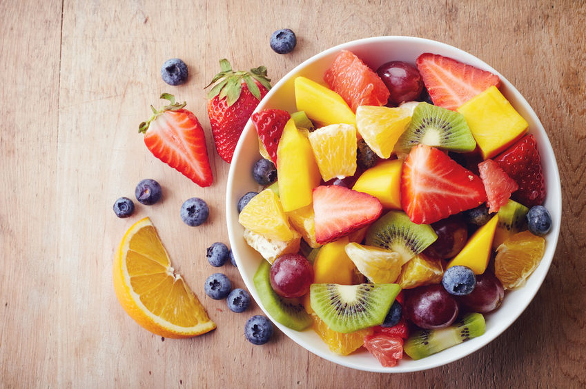 Bowl+of+healthy+fresh+fruit+salad+on+wooden+background.+Top+view.